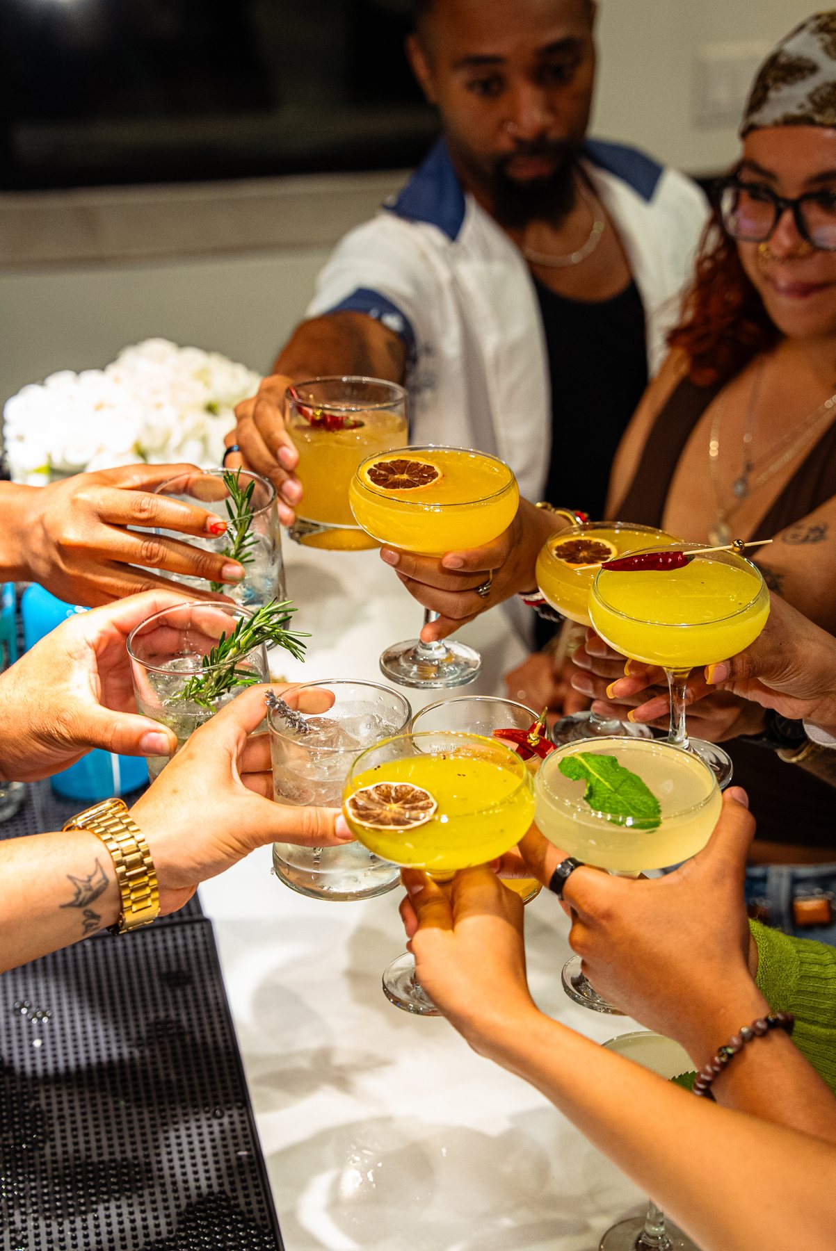 Guests raising signature cocktails in a toast