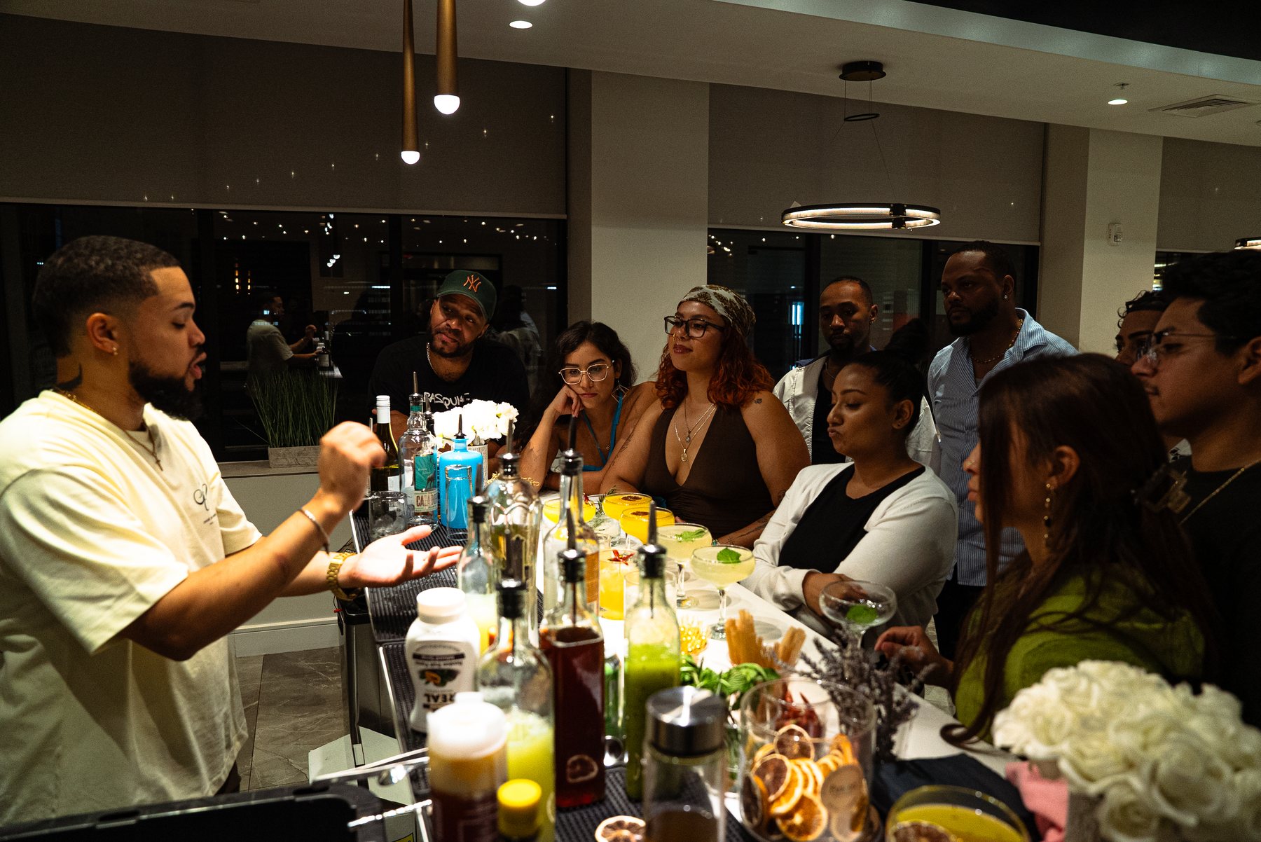 Drinkswitpapiii cocktail class with guests around the bar