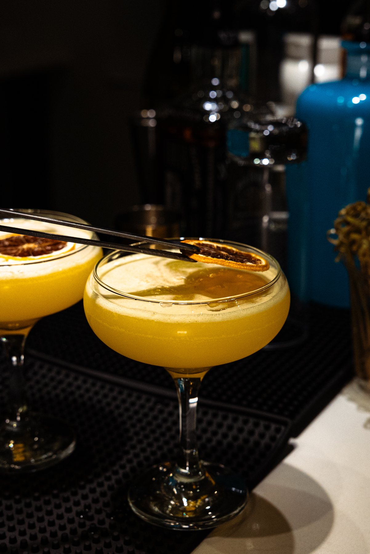 Garnishing a yellow coupe cocktail
