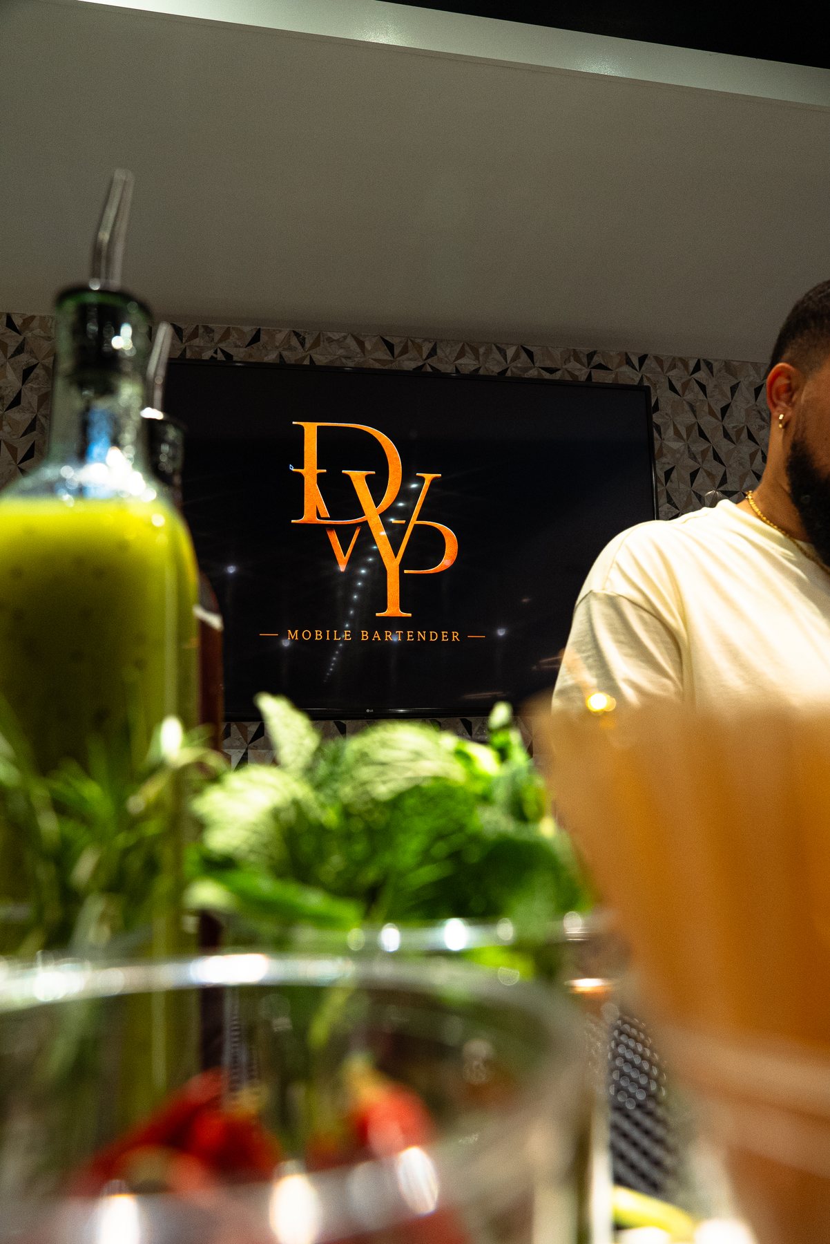 Drinkswitpapiii logo behind fresh bar ingredients