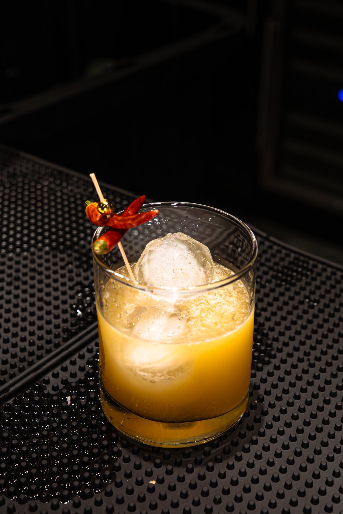 Orange cocktail with chile garnish