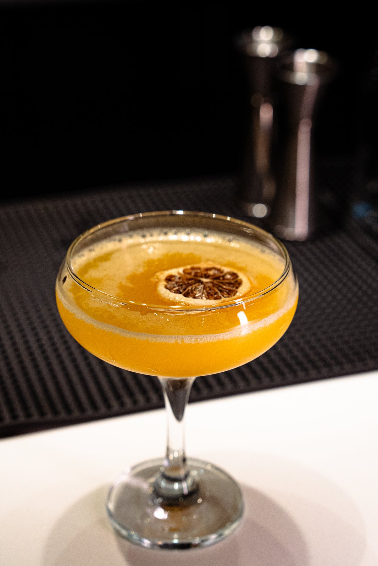 Orange coupe cocktail with citrus garnish